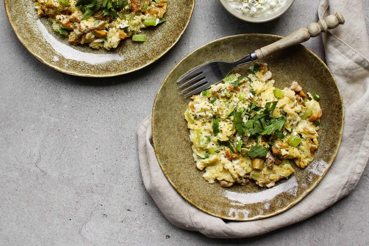 Omlette with chanterelles on a rustic plate with dip
