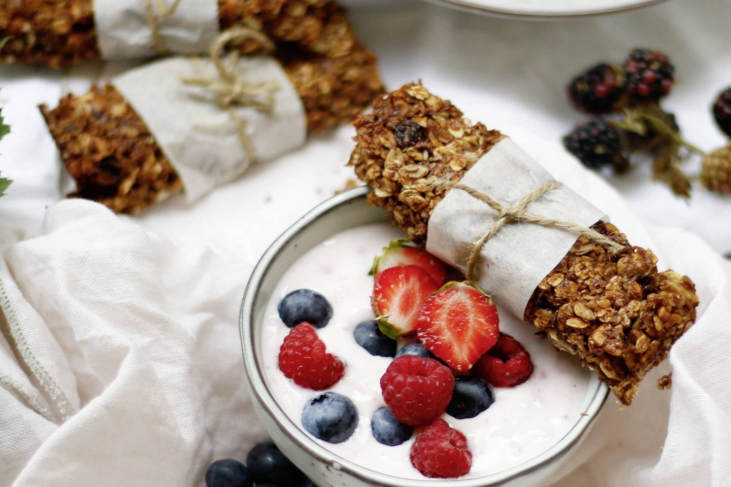 Mueslibar on a bowl with berries and yogurt
