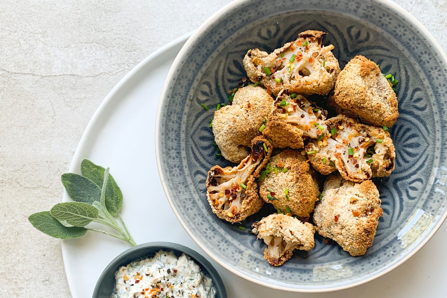 Cauliflower Nuggets in a bowl with a dip