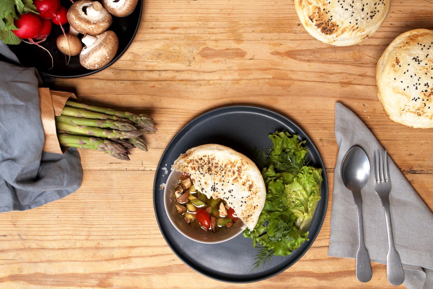 Rainbow bowl with vegetables on a wooden table
