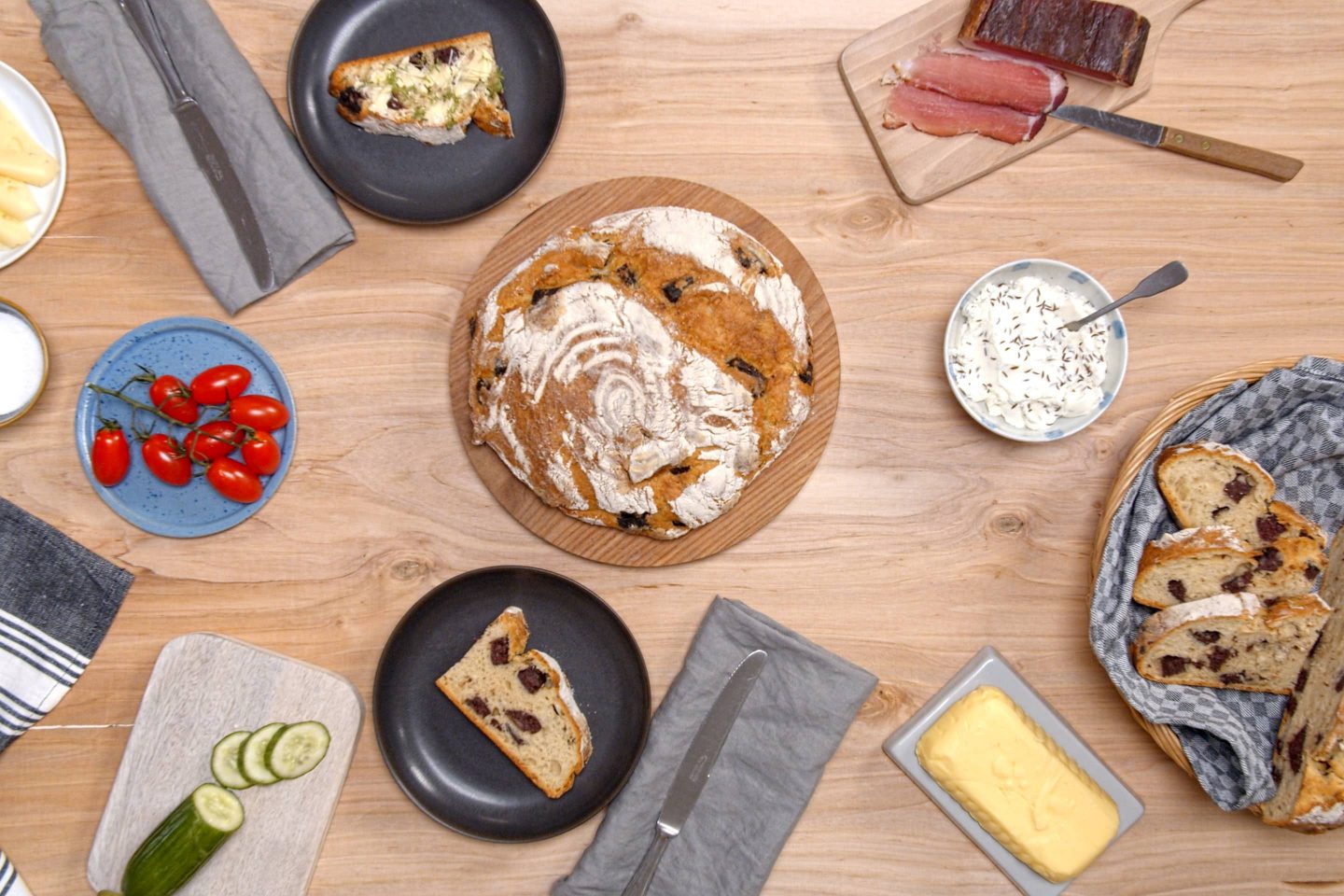 a whole loaf of Blunznbrot in the middle of a well-laid snack table
