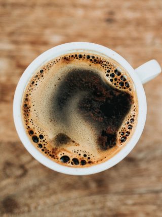 Topshotof a cup of cup on a wooden table