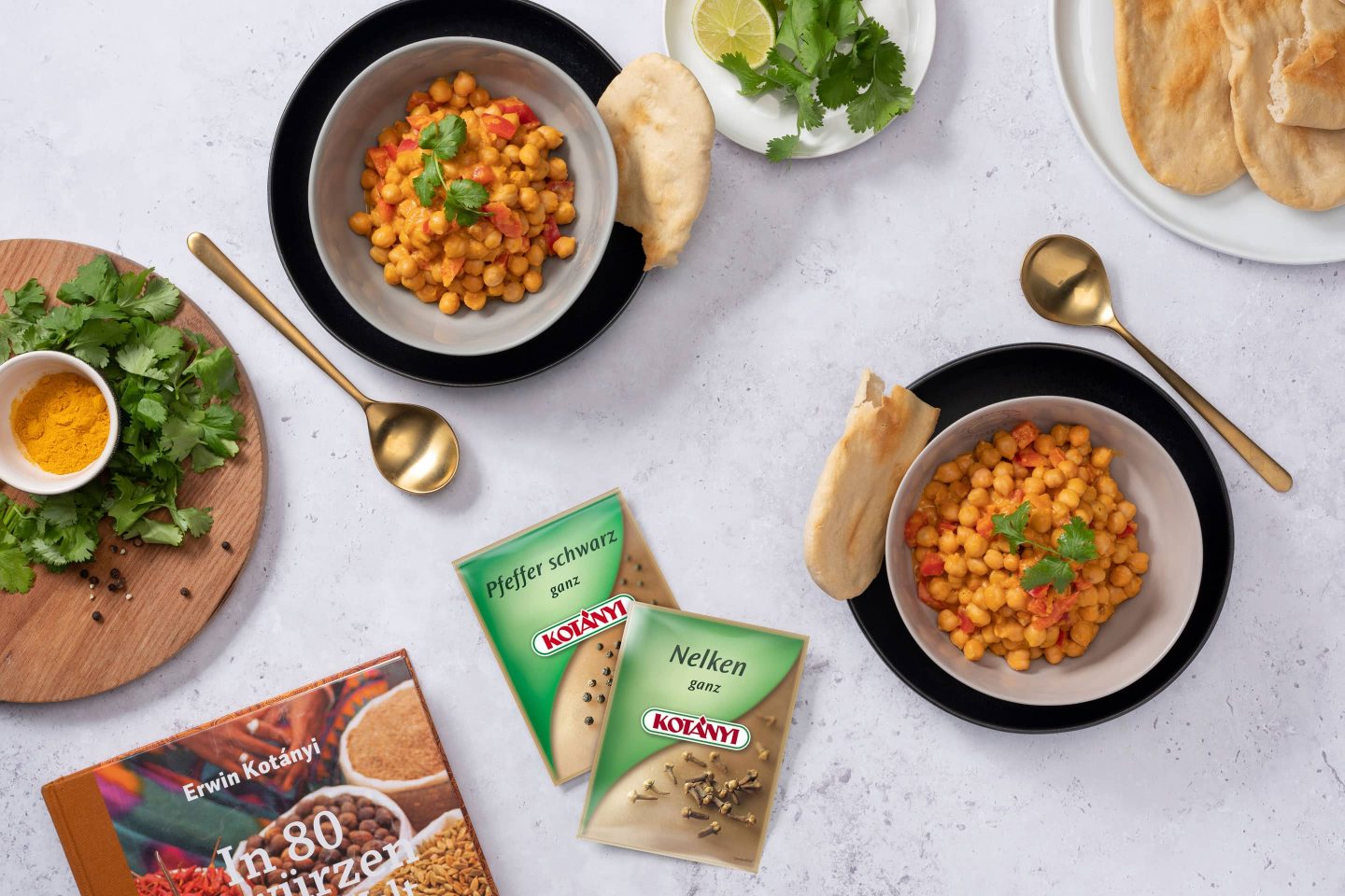 Chickpea curry with naan beside sachets of black pepper and whole cloves.