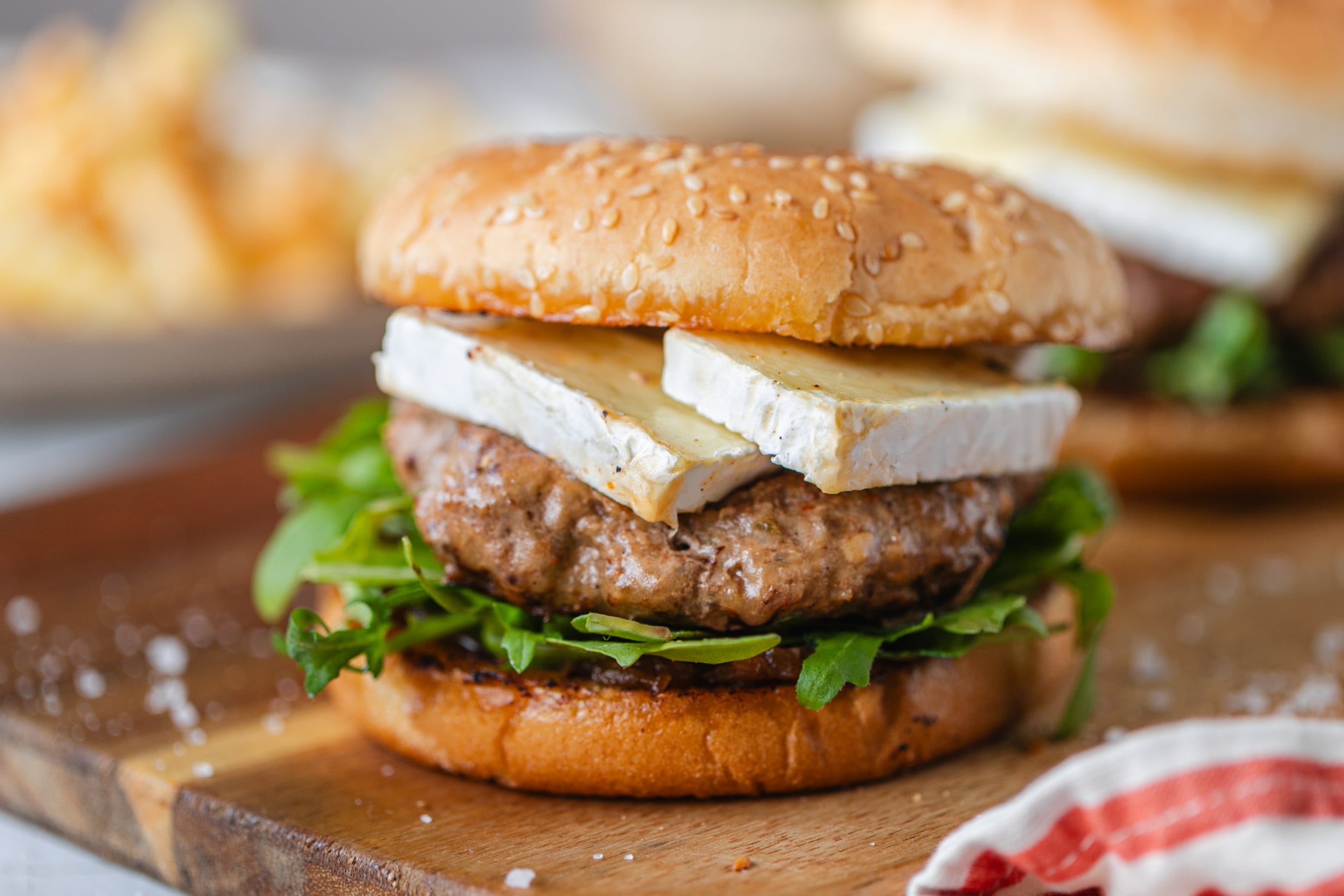 Burgers With Caramelized Onion Arugula And Brie Min
